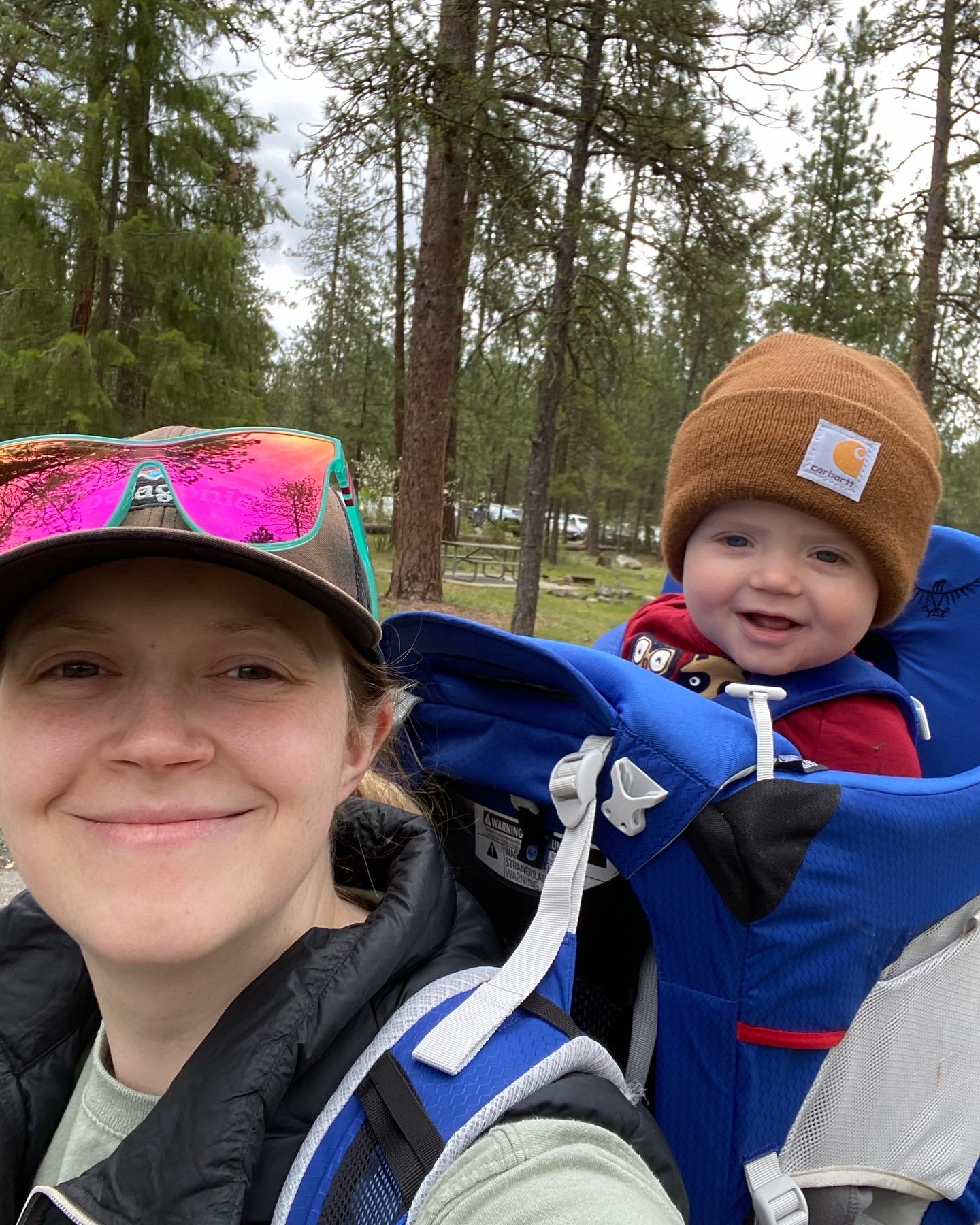 woman with baby in back pack outside